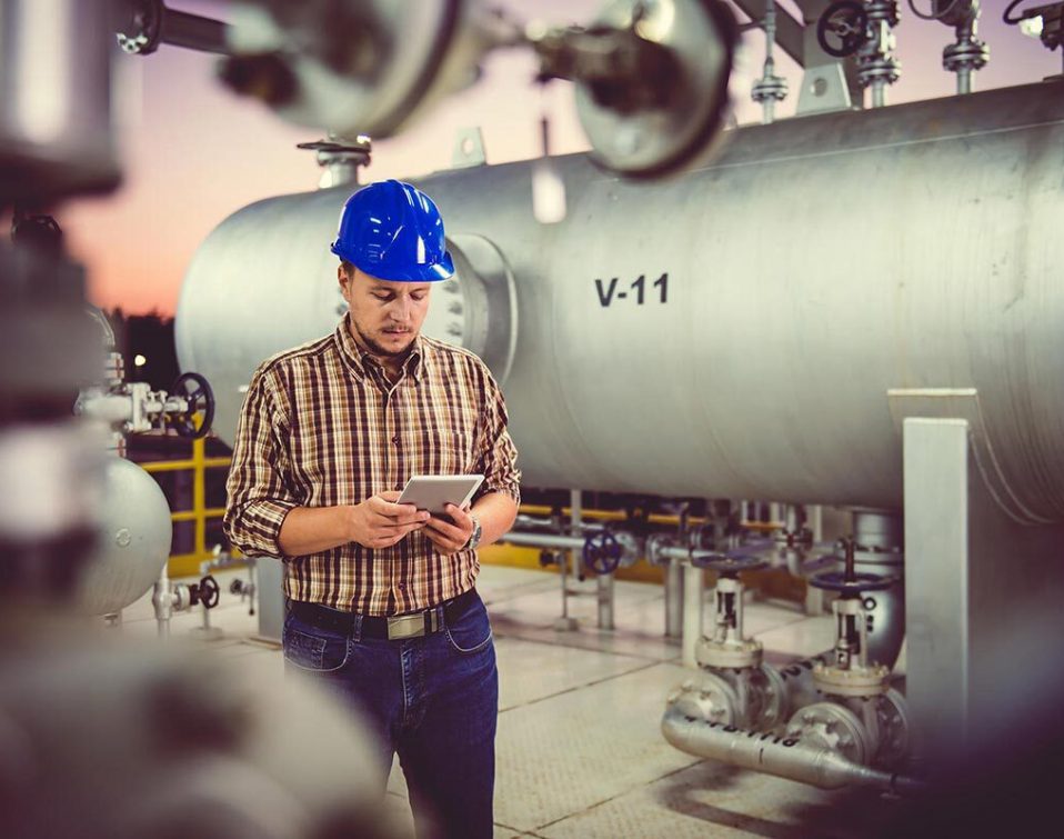 A male industrial worker looking at a tablet
