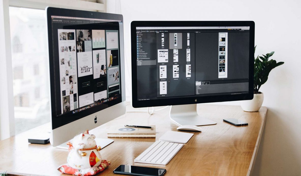 Two mac monitors on a desk