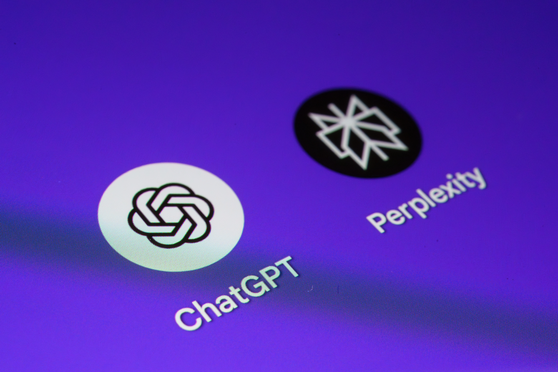ChatGPT and Perplexity app icons displayed side by side on smartphone with purple background