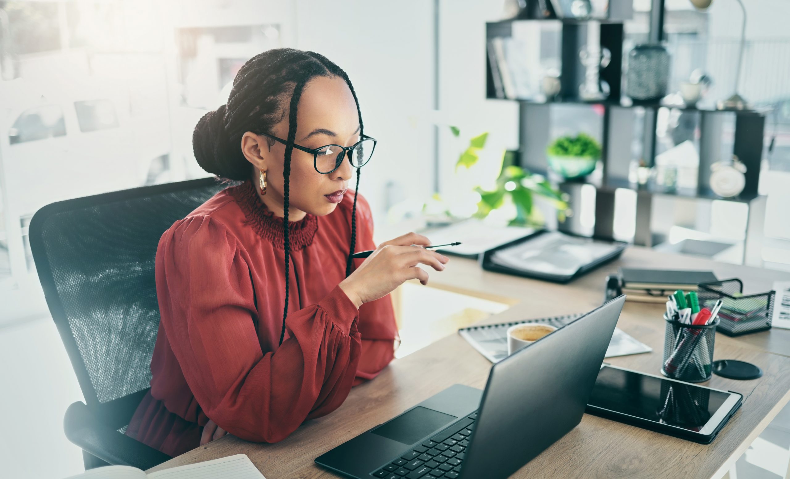 Business woman, computer and office desk for online editing, marketing research and planning. Professional african person, editor or worker reading email, social media copywriting and email on laptop.